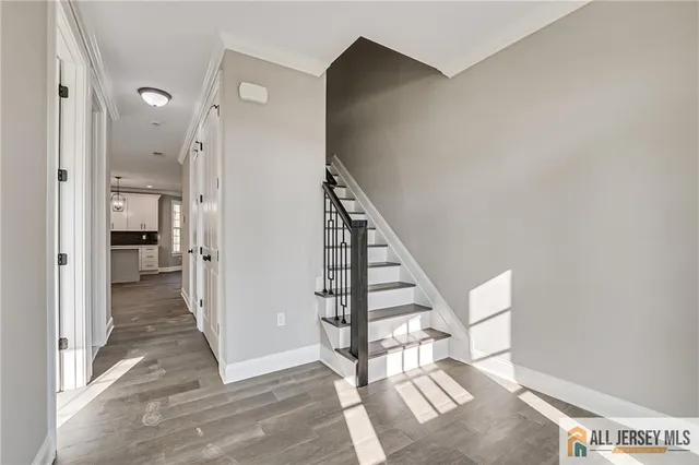 a view of a hallway with wooden floor and entryway