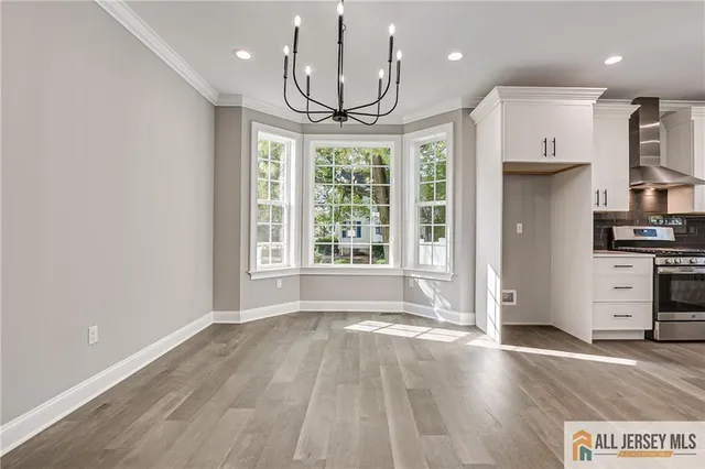 a view of a kitchen with wooden floor and a window