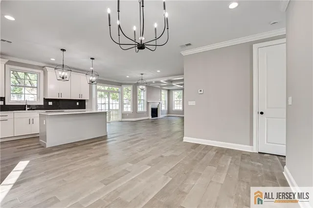 a view of a kitchen with a sink stainless steel appliances and cabinets