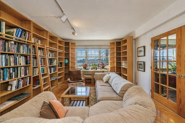 a living room with furniture and a floor to ceiling window
