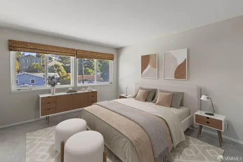 a bedroom with a bed and a large window