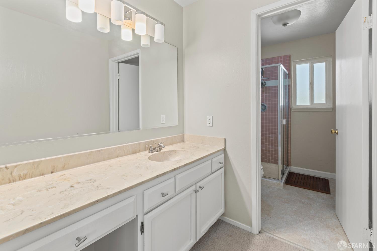1059 El Centro Avenue, Unit 3 Oakland, CA 94602 - Photo 17 of 25 a spacious bathroom with a granite countertop sink and a mirror
