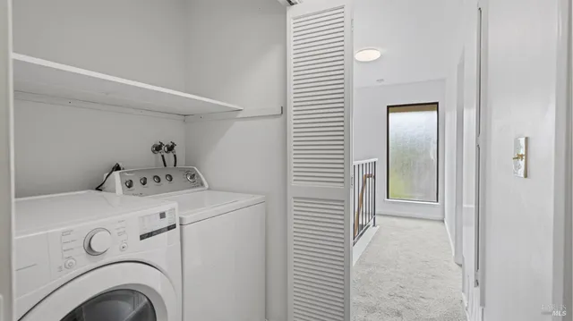 a view of storage and utility room with washer and dryer