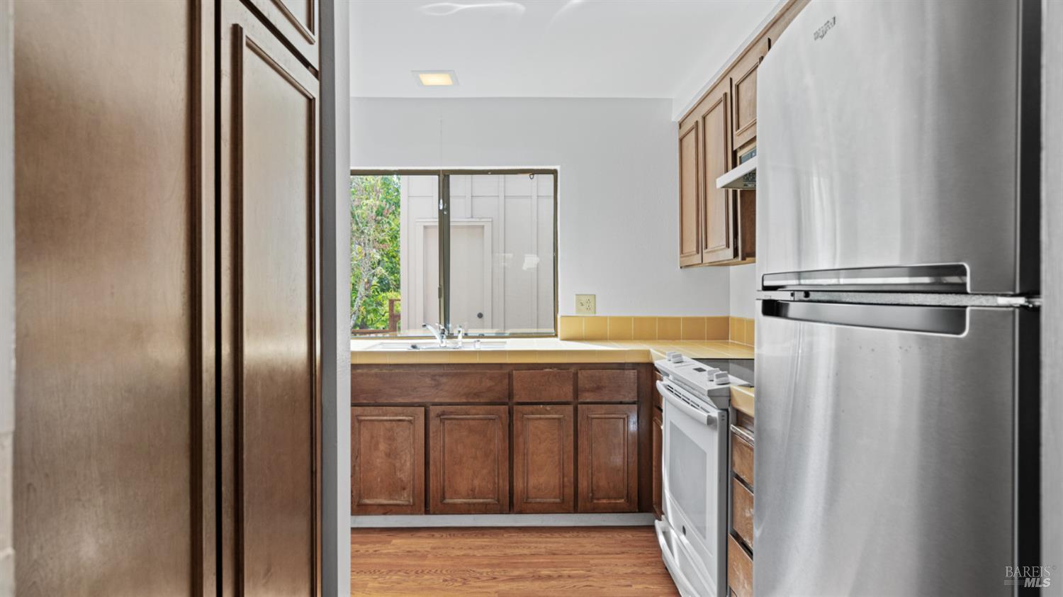 19 Burdell Court Novato, CA 94949 - Photo 6 of 30 a bathroom with a granite countertop sink and a mirror