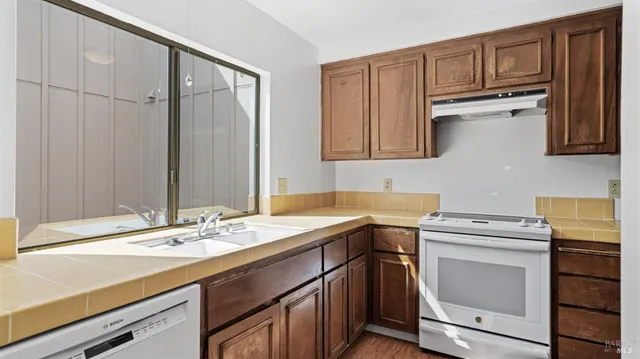 a utility room with cabinets washer and dryer