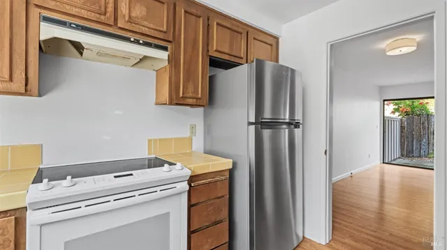 a kitchen with a refrigerator and cabinets