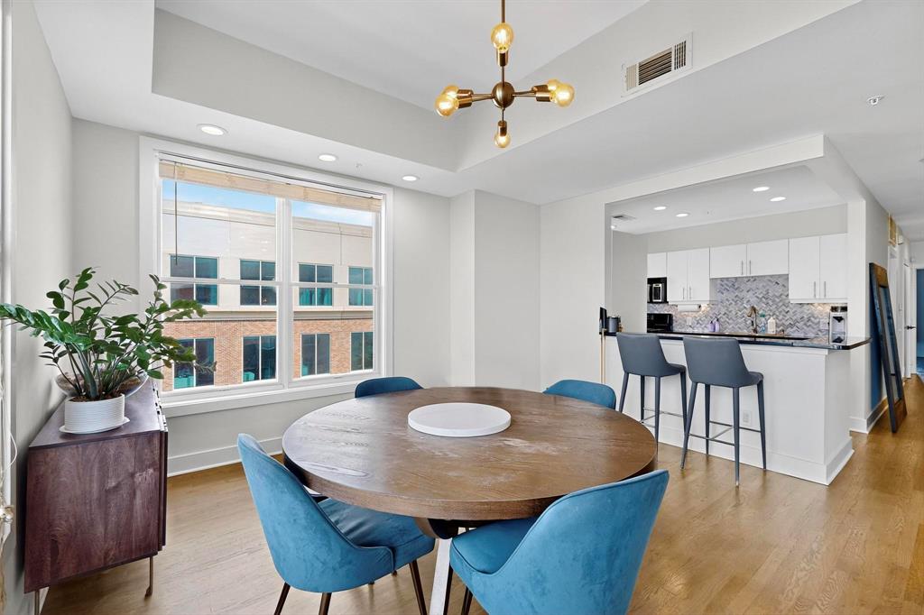 5055 Addison Circle, Unit 736 Addison, TX 75001 - Photo 11 of 34 a view of a dining room with furniture and wooden floor