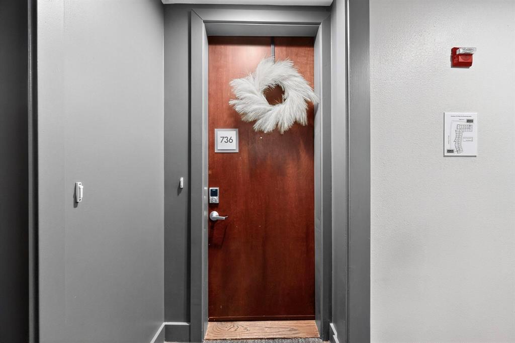 5055 Addison Circle, Unit 736 Addison, TX 75001 - Photo 16 of 34 a view of a hallway with wooden floor