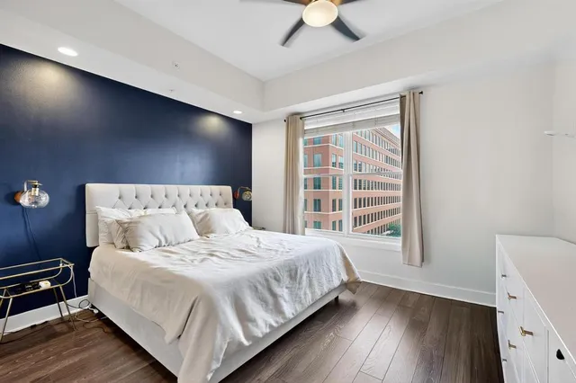 a bedroom with a large bed and a large window