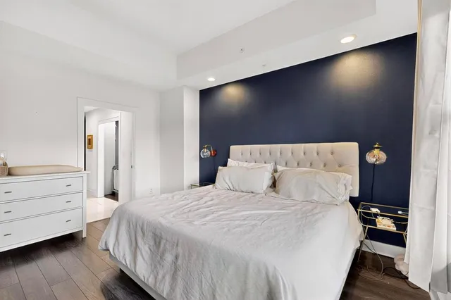 a bedroom with a bed and a flat screen tv