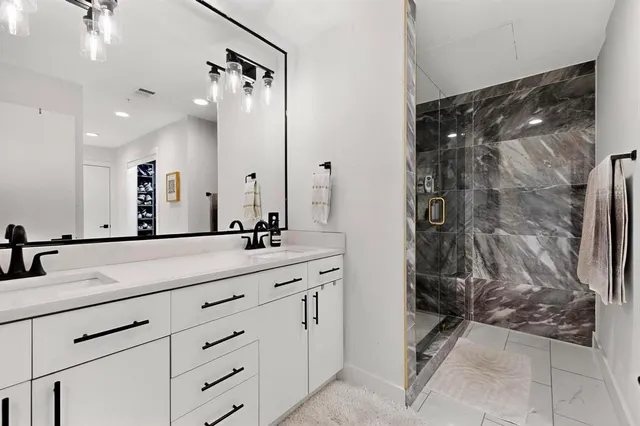 a spacious bathroom with a shower sink and mirror