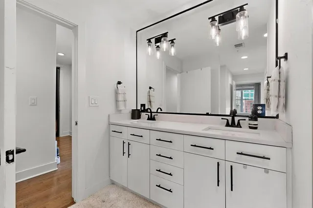 a bathroom with a double vanity sink mirror and double