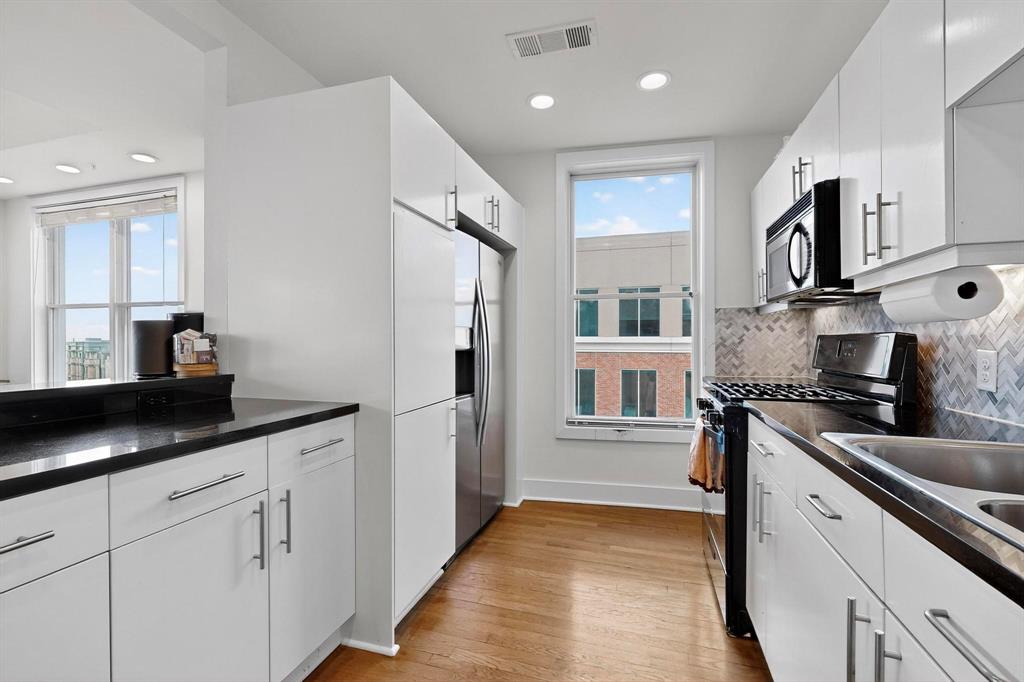 5055 Addison Circle, Unit 736 Addison, TX 75001 - Photo 6 of 34 a kitchen with stainless steel appliances granite countertop a refrigerator and a sink