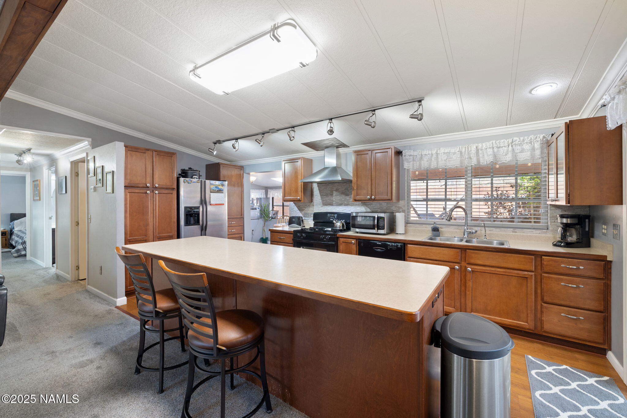 2401 West Rte 66 Flagstaff, AZ 86001 - Photo 13 of 47 a kitchen with stainless steel appliances granite countertop a sink a stove a refrigerator cabinets and chairs