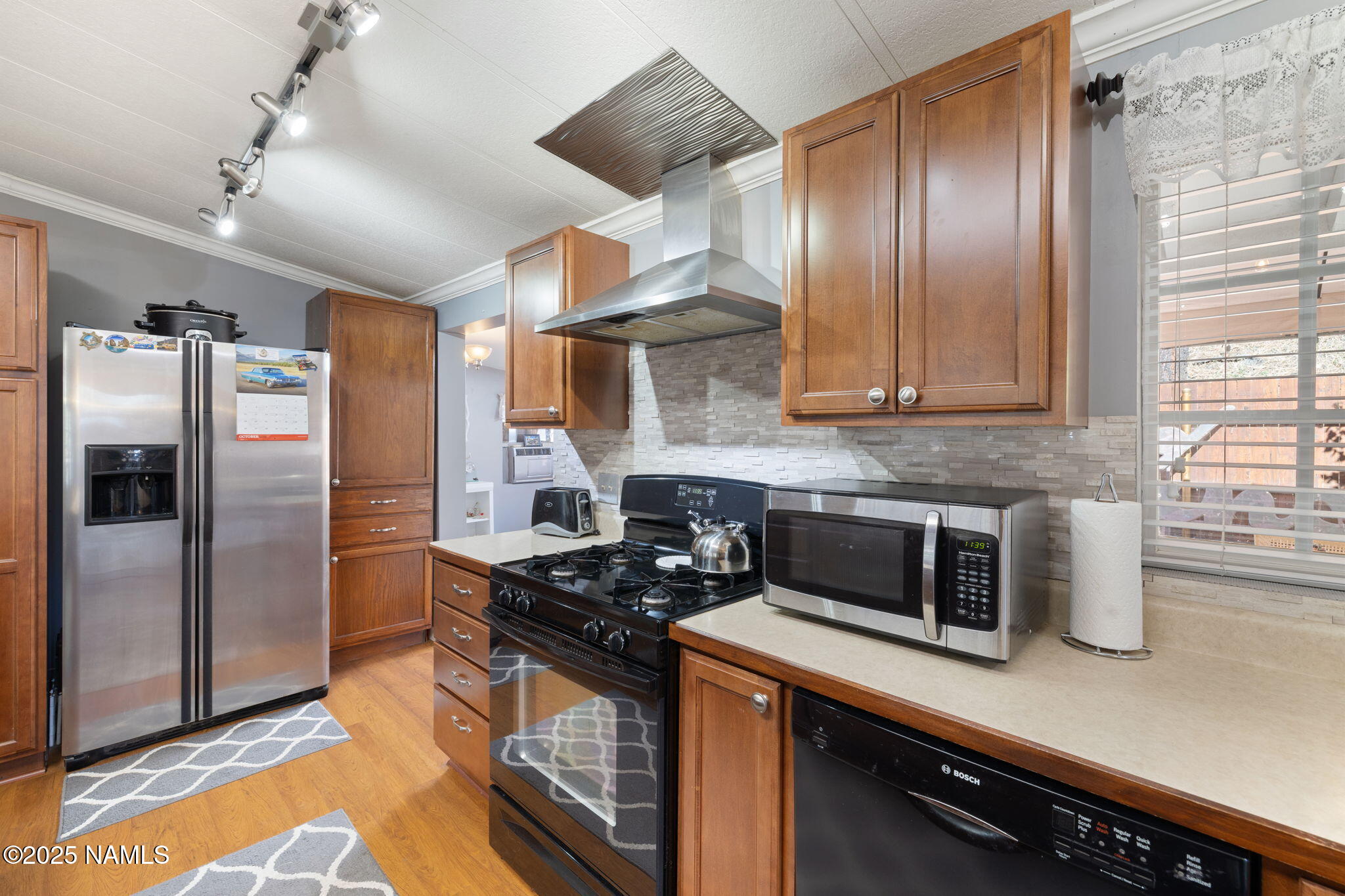 2401 West Rte 66 Flagstaff, AZ 86001 - Photo 15 of 47 a kitchen with stainless steel appliances granite countertop a refrigerator a stove and a sink with wooden floor