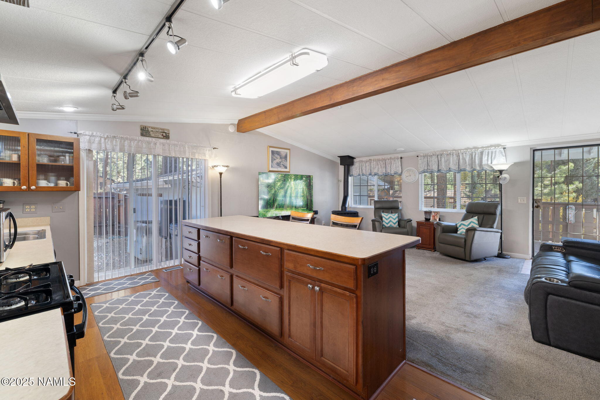 2401 West Rte 66 Flagstaff, AZ 86001 - Photo 17 of 47 a large kitchen with kitchen island a large counter space a sink stainless steel appliances and cabinets