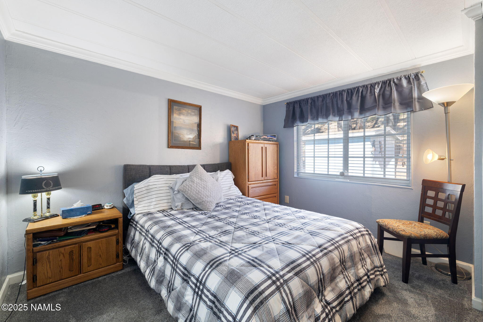 2401 West Rte 66 Flagstaff, AZ 86001 - Photo 28 of 47 a bedroom with a bed and wooden floor