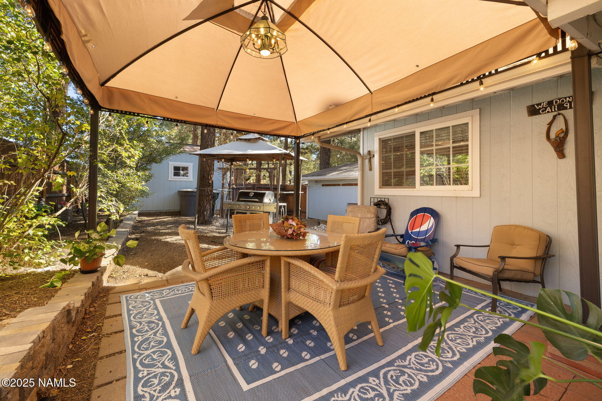 2401 West Rte 66 Flagstaff, AZ 86001 - Photo 30 of 47 a view of a patio with table and chairs under an umbrella