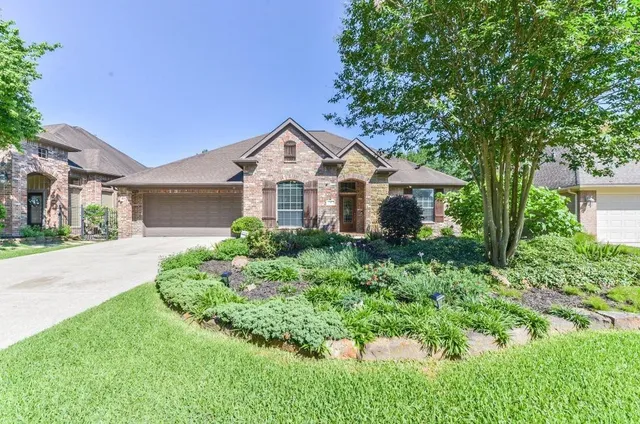 a front view of a house with a yard and potted plants