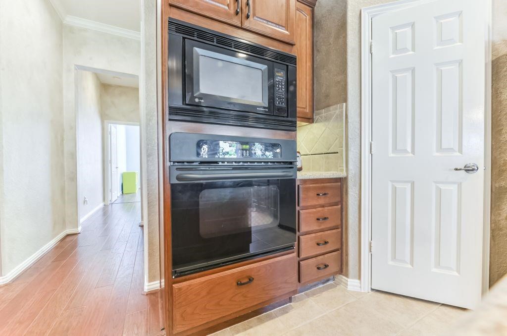 31 North Warbler Bend Circle Spring, TX 77382 - Photo 12 of 31 a stove top oven sitting inside of a kitchen