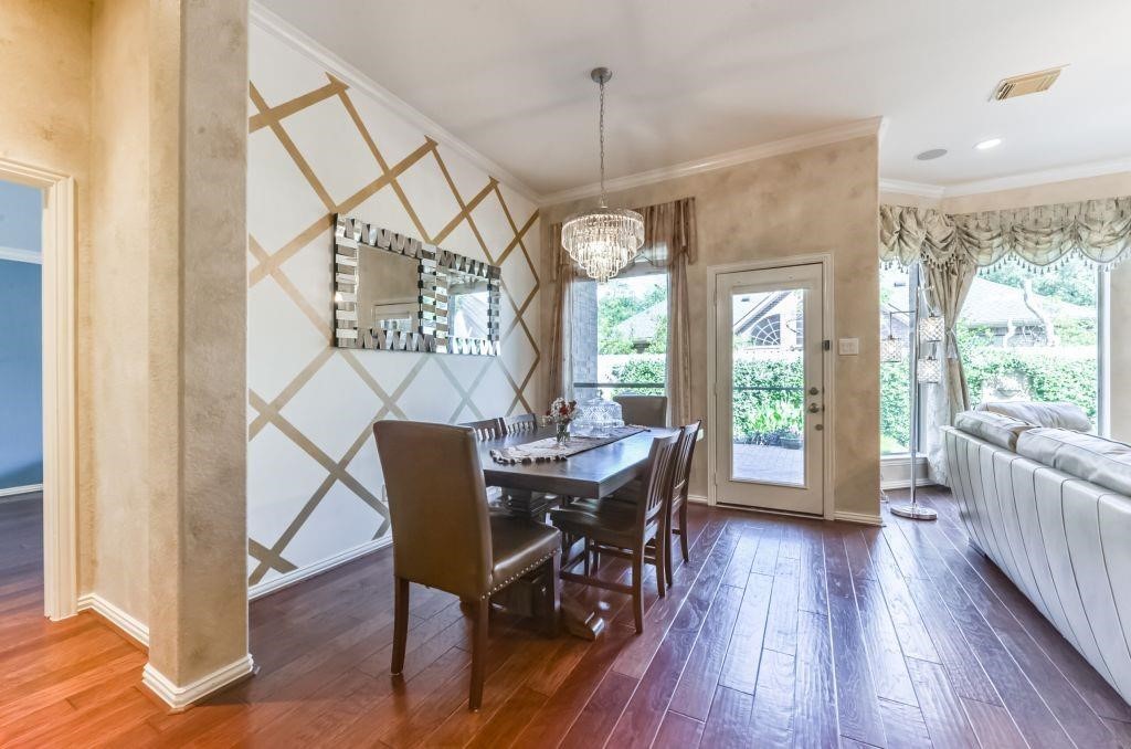31 North Warbler Bend Circle Spring, TX 77382 - Photo 15 of 31 a dining room with furniture a chandelier and wooden floor