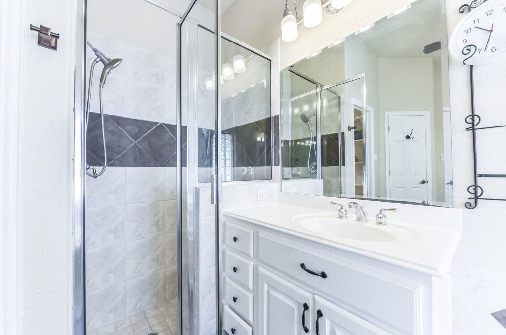31 North Warbler Bend Circle Spring, TX 77382 - Photo 20 of 31 a bathroom with a shower sink and mirror
