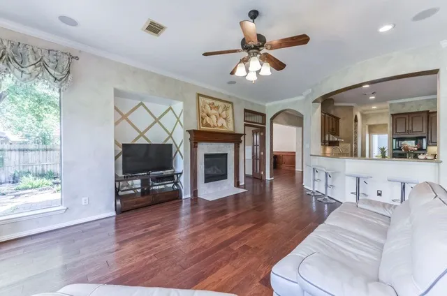 a living room with furniture a fireplace and a flat screen tv