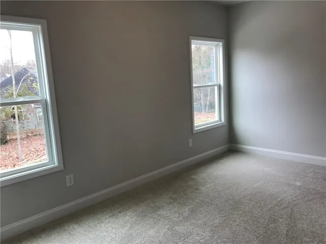 a view of staircase with white walls and a window