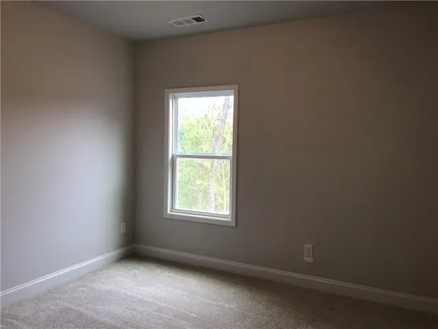 a view of a hallway with wooden floor and entryway