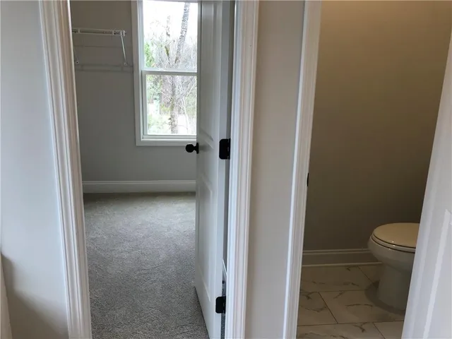 a large kitchen with stainless steel appliances kitchen island a large counter top and a wooden floors