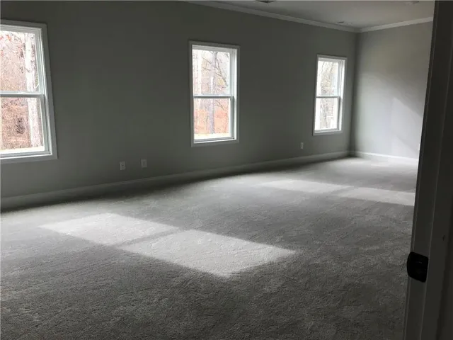a view of an entryway with wooden floor and windows