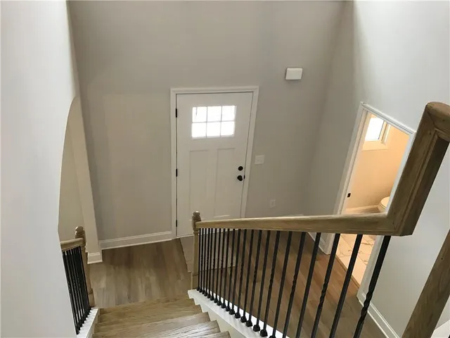 a bathroom with a granite countertop toilet and a sink