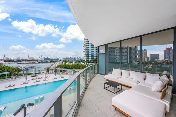 a balcony with furniture and city view