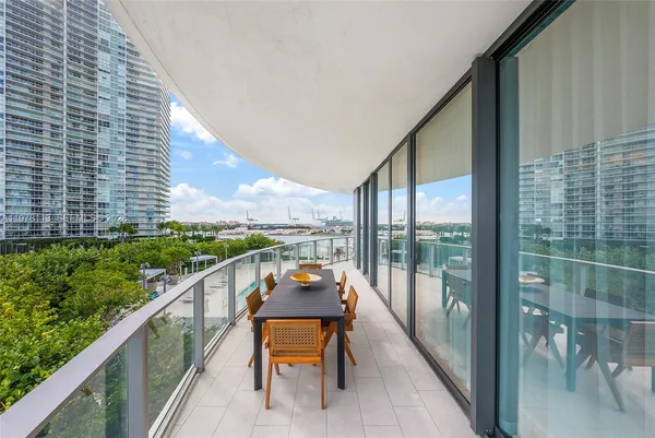a city view from balcony with furniture