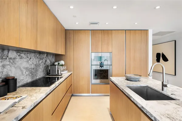 a kitchen with a sink and a refrigerator