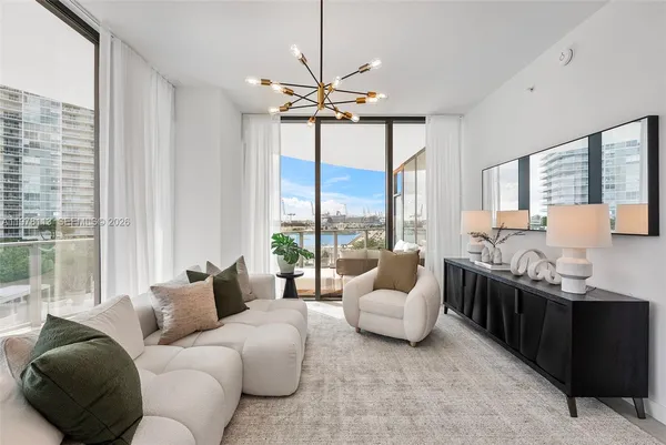 a living room with furniture and large windows