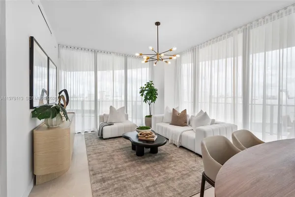 a living room with furniture and a chandelier