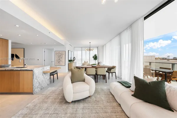 a large dining space with furniture a rug and a view