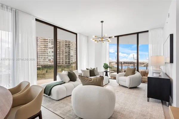 a living room with furniture and large windows