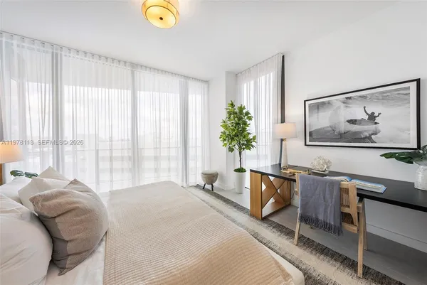 a bedroom with a bed and a lamp