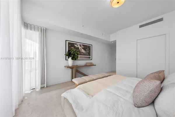 a bedroom with bed and a window