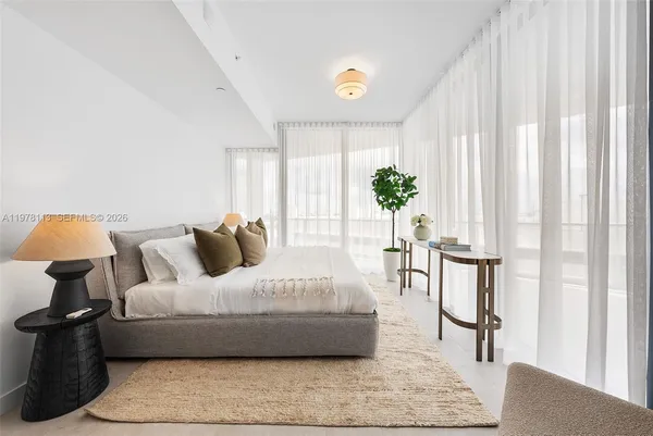 a bedroom with a bed and a potted plant