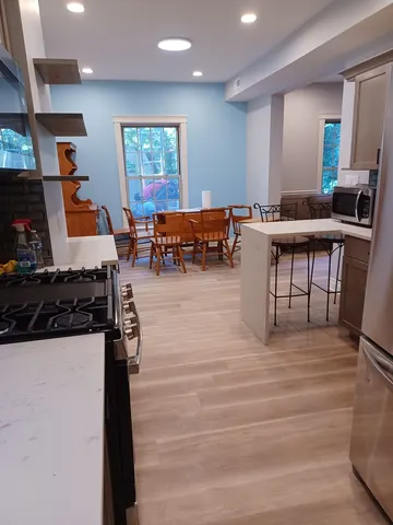 a living room with furniture a flat screen tv and a large window