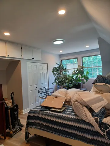 a bedroom with furniture and a window