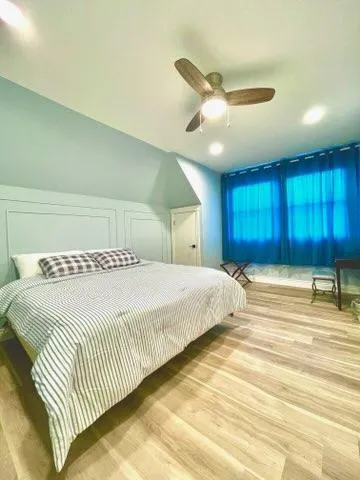 a bedroom with a large bed and a chandelier