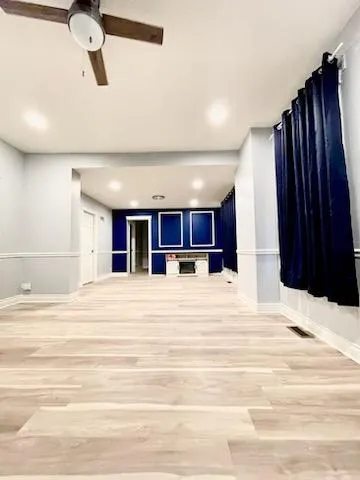 a view of a livingroom with a furniture and ceiling fan
