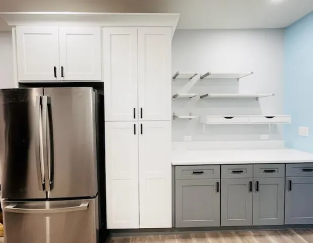 a kitchen with cabinets and stainless steel appliances