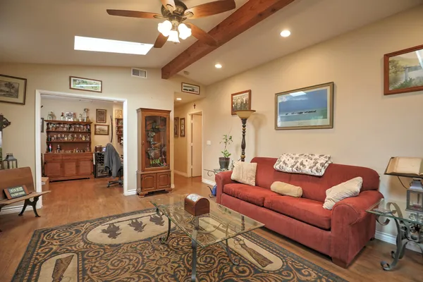 a living room with furniture a flat screen tv and a rug