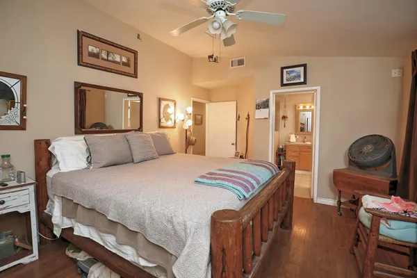 a bedroom with a bed and wooden floor