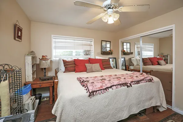 a bedroom with a bed and wooden floor